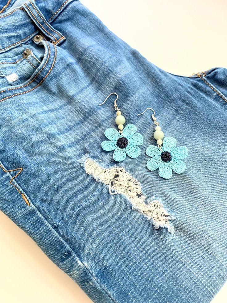 "Fun, summer style, and unique blue flower earrings!  These beaded crochet earrings made with a shiny polyester thread forming a delicate lace flower. Semi precious gemstones are also added. The blue flowers are 1.5\" in diameter and the drop length of these flower dangle earrings is 2.5\". All of BloomingSpringDesign's products are made in a smoke and pet free environment.  They are designed joyfully and delicately produced. My aim is to make you happy with your purchase, so if you are not fully satisfied with them please contact me. Your purchase will arrive gift wrapped. If you would like a handwritten note added as a part of a gift, please let me know.  If these blue flower earrings are not exactly what you are looking for, please check the rest of my handmade earrings designs; https:/ Blue Flower-shaped Summer Earrings, Blue Flower Shaped Earrings For Summer, Blue Dangle Flower Earrings For Spring, Blue Earrings With Flower Charm For Spring, Blue Flower Charm Earrings For Spring, Light Blue Flower Earrings For Spring, Handmade Light Blue Jewelry For Summer, Blue Bohemian Flower Earrings, Handmade Flower-shaped Earrings For Summer