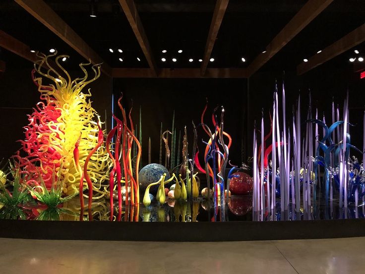 an artistic display with many different colored glass objects