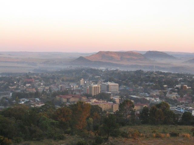 the city is surrounded by hills and trees