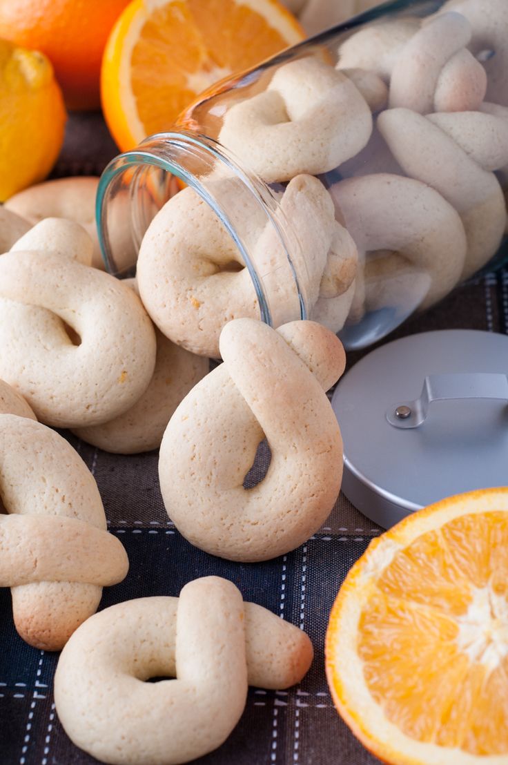 an assortment of cookies and oranges on a table