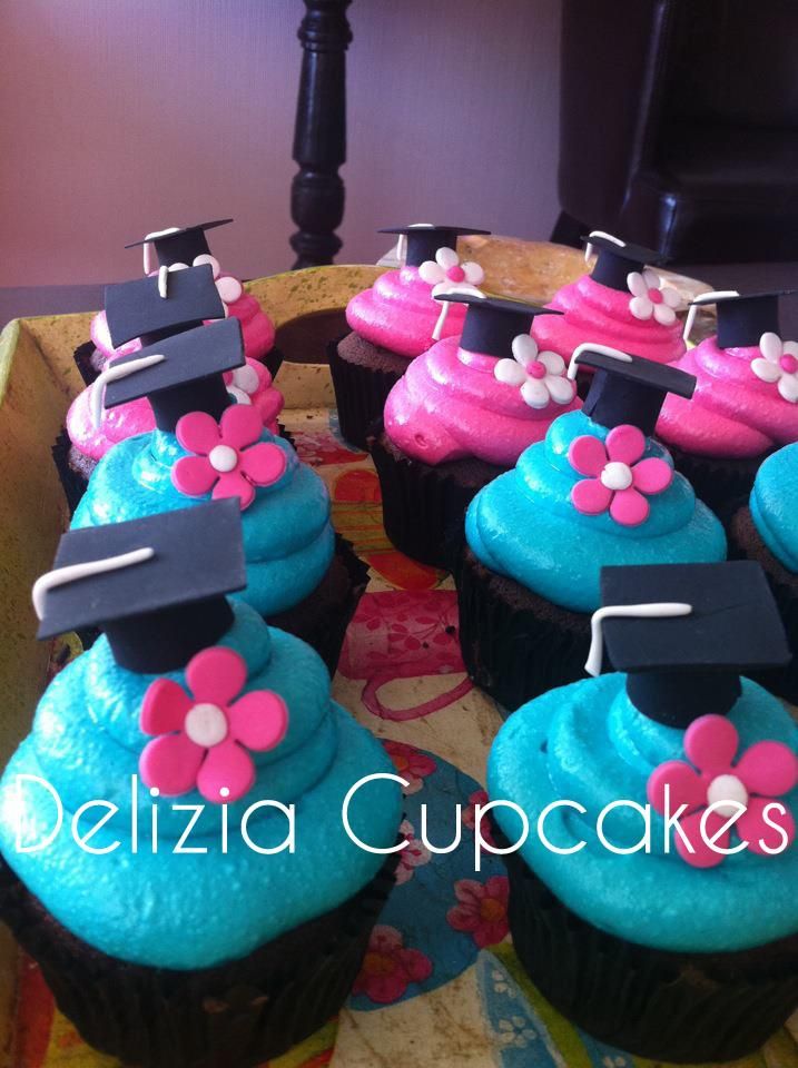 cupcakes decorated with blue frosting and pink flowers