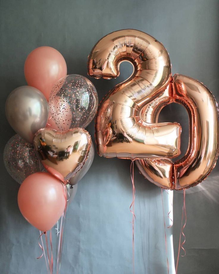 the number twenty five is surrounded by balloons and streamers in gold, silver, and pink