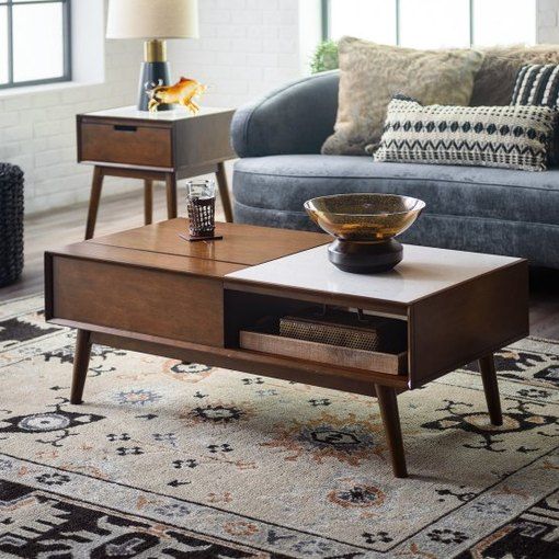 a living room with a couch, table and two end tables in front of it