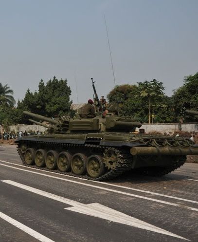 an army tank is driving down the street