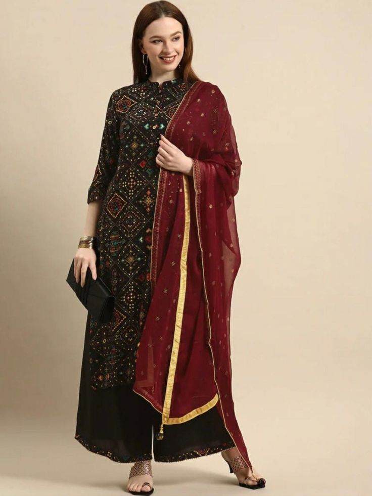 HAND CRAFTED KURTA SET DESCRIPTION *Black printed Kurta with Palazzos with dupatta Kurta design:- * Ethnic motifs printed * A-line shape * Regular style * Mandarin collar, three-quarter regular sleeves * Knee length with straight hem * Viscose rayon knitted and woven fabric *Fabric:- Top fabric:  Rayon  Bottom fabric:  Rayon  Dupatta fabric:  Cotton Blend    *Wash Care:- Machine wash AVAILABLE IN 7 SIZES THEY ARE IN FOLLOWING MEASUREMENTS IN INCHES:- XXS:- Bust-32/Shoulder-13/Top Length-46/Botto Bagh Print Suits Design, Red Plazo, Indian Party Wear Dresses, Black Kurti, Kurta With Palazzo, Party Wear Dress, Kurta Set For Women, Ethnic Motifs, Indian Party