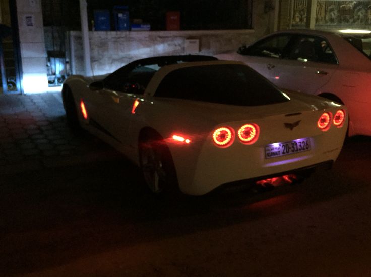 two white cars parked next to each other