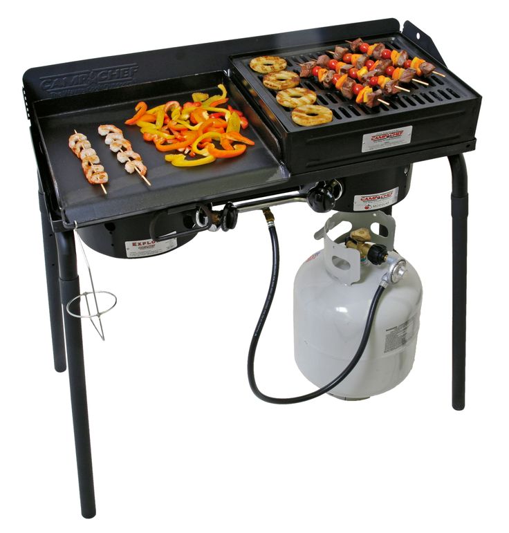 two grills with food cooking on them and a propane gas tank underneath it