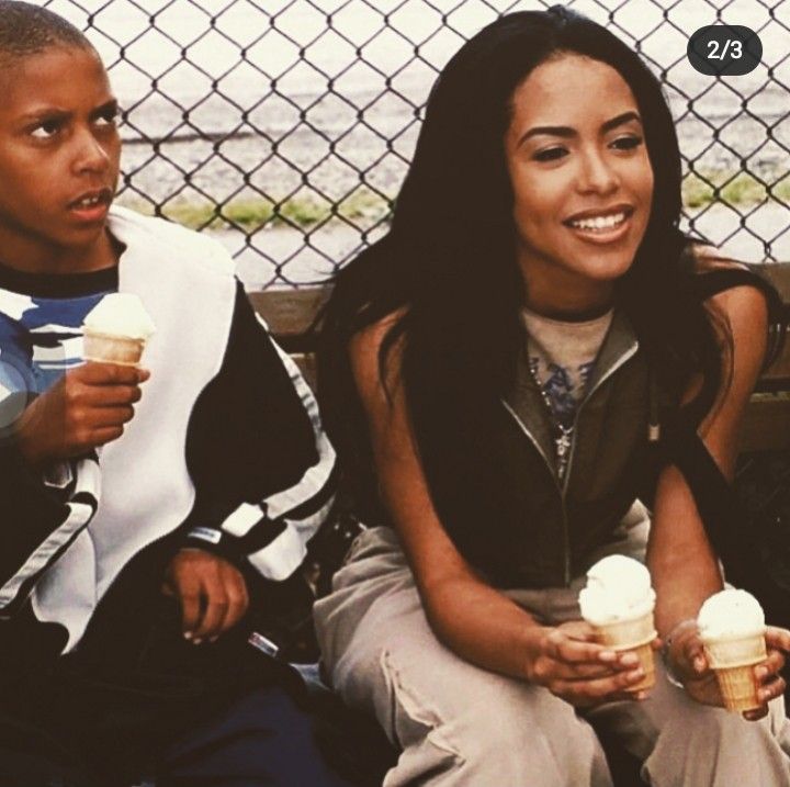 two people sitting on a bench with ice cream cones in their hands and one person holding an ice cream cone