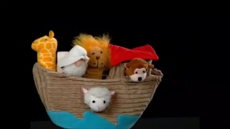 there are stuffed animals in a boat made out of paper mache and cloths