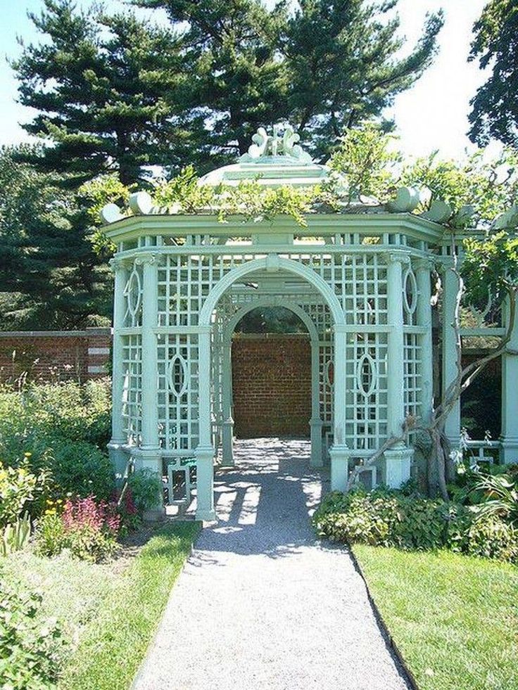 an outdoor garden with a gazebo and flowers