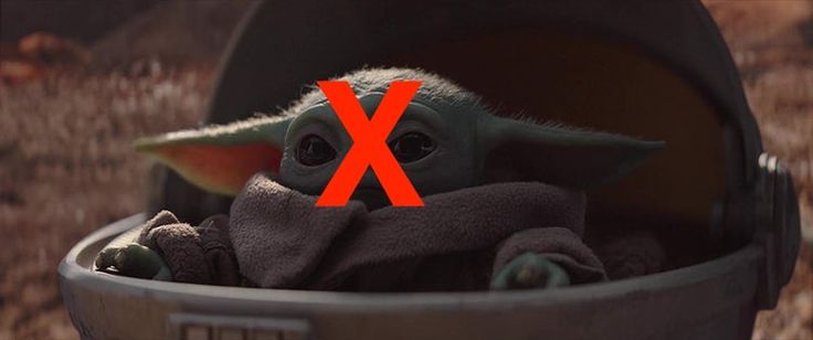 a baby yoda is sitting in a barrel with the x on it's side