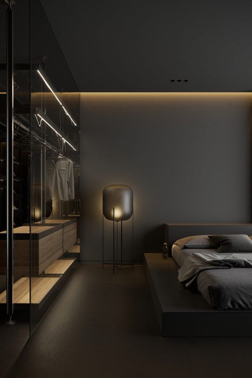 a bedroom with a large bed in the middle and some lights on either side of it