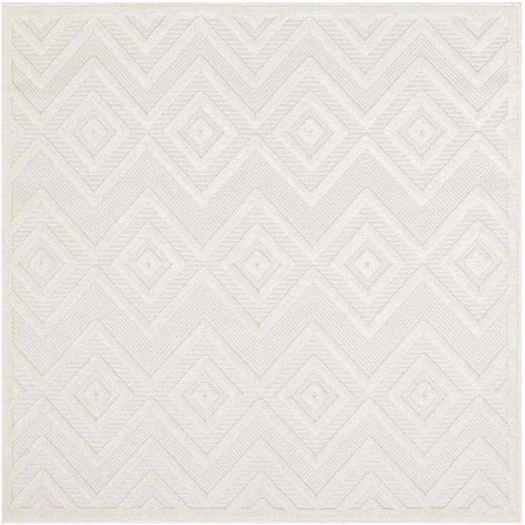 a white rug with an abstract design on the bottom, and a diamond pattern in the middle