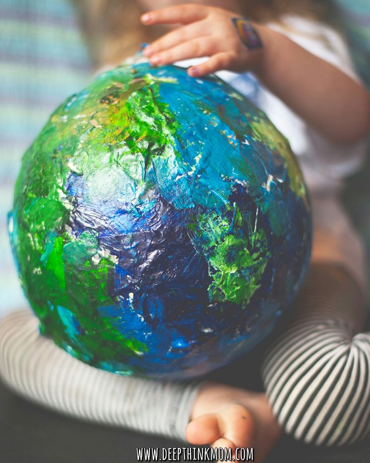 a child holding a globe with the words how to make paper mache planets