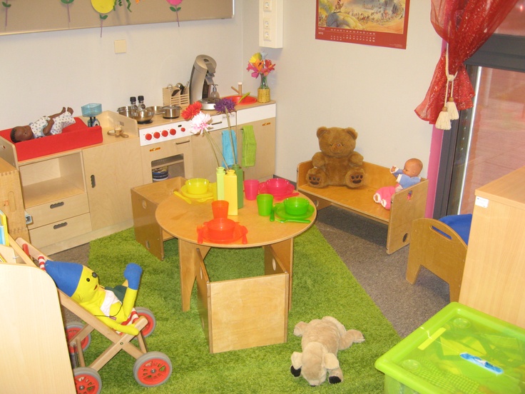 a child's playroom with toys and other items on the carpeted floor