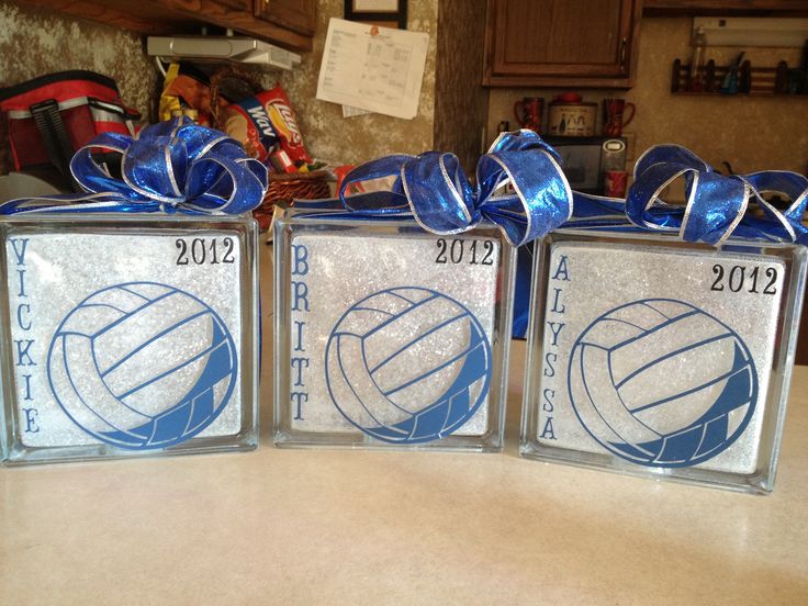 three clear boxes with blue ribbons tied around them on top of a counter in a kitchen