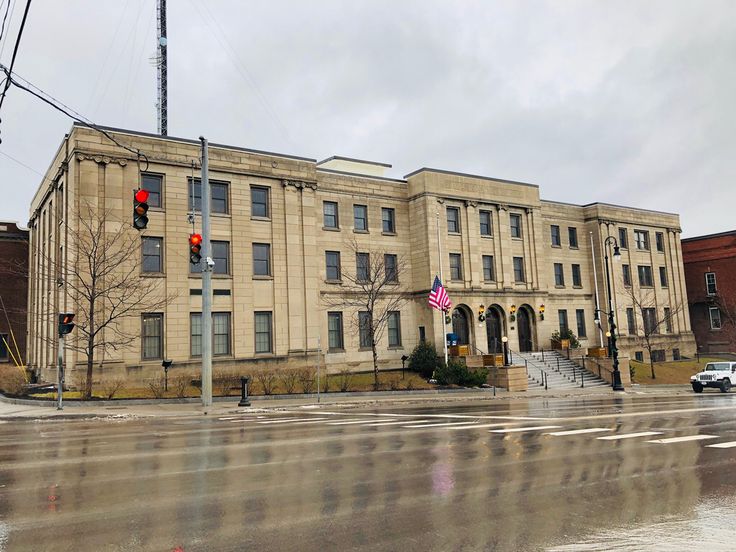 an old building on the corner of a wet street