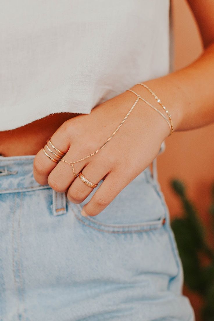 Channel your inner bohemian with this hand chain that loosely drapes around your finger and wrist. Whether you’re at a music festival or brunch with the girls, this hand candy turns any outfit into magic. Bracelet is 6" with a 1" extender. S/M: ring size 5-7.5, wrist size 6-7" M/L: ring size 8-10.5, wrist size 7-7.5" Available in 14kt Gold Fill + Sterling Silver. Handmade in Eau Claire, WI. Our jewelry is handmade so each piece will be unique and may vary slightly from what is pictured. Bohemian Body Jewelry With Adjustable Chain For Summer, Bohemian Spring Bracelet, Adjustable Chain Body Jewelry For Festivals, Gold Bracelets With Adjustable Chain For Festival, Dainty Summer Bracelets With Adjustable Chain, Dainty Summer Bracelet With Adjustable Chain, Hand Wrapped Bracelet Jewelry For Party, Trendy Adjustable Jewelry, Bohemian Hand Wrapped Bracelets For Party