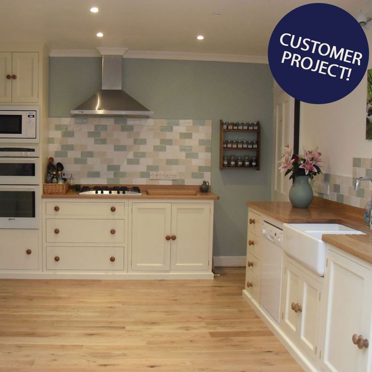 a large kitchen with white cabinets and wood flooring is featured in the ad for customer project