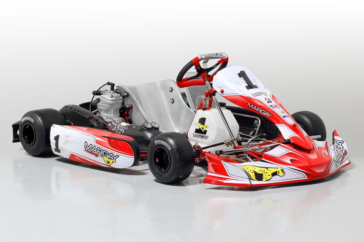 a red and white race car is shown in this studio photo, with the front wheels facing forward