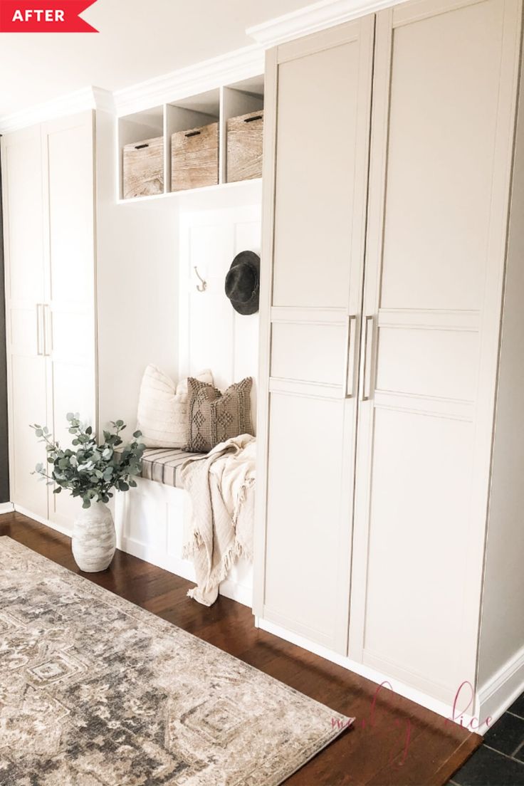 a living room with white cabinets and a rug on the floor in front of it