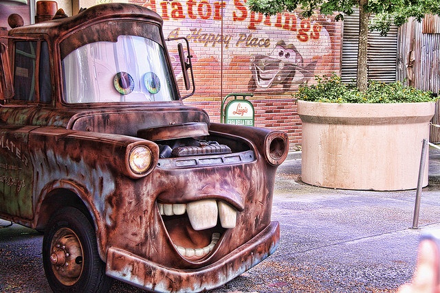 an old rusted truck with a big grin on it's face