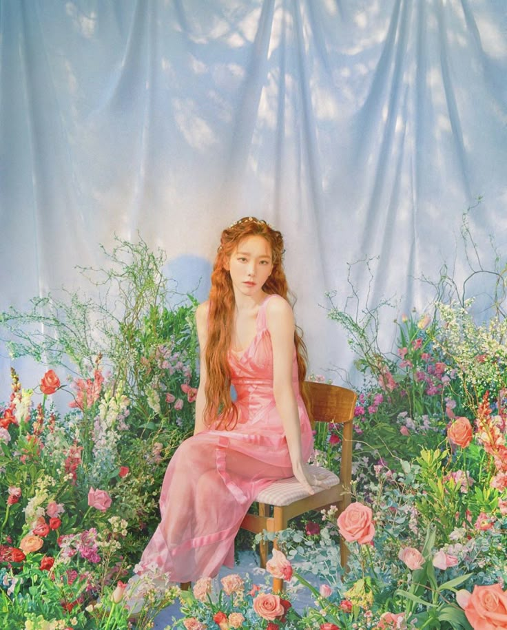 a painting of a woman sitting on a chair surrounded by flowers