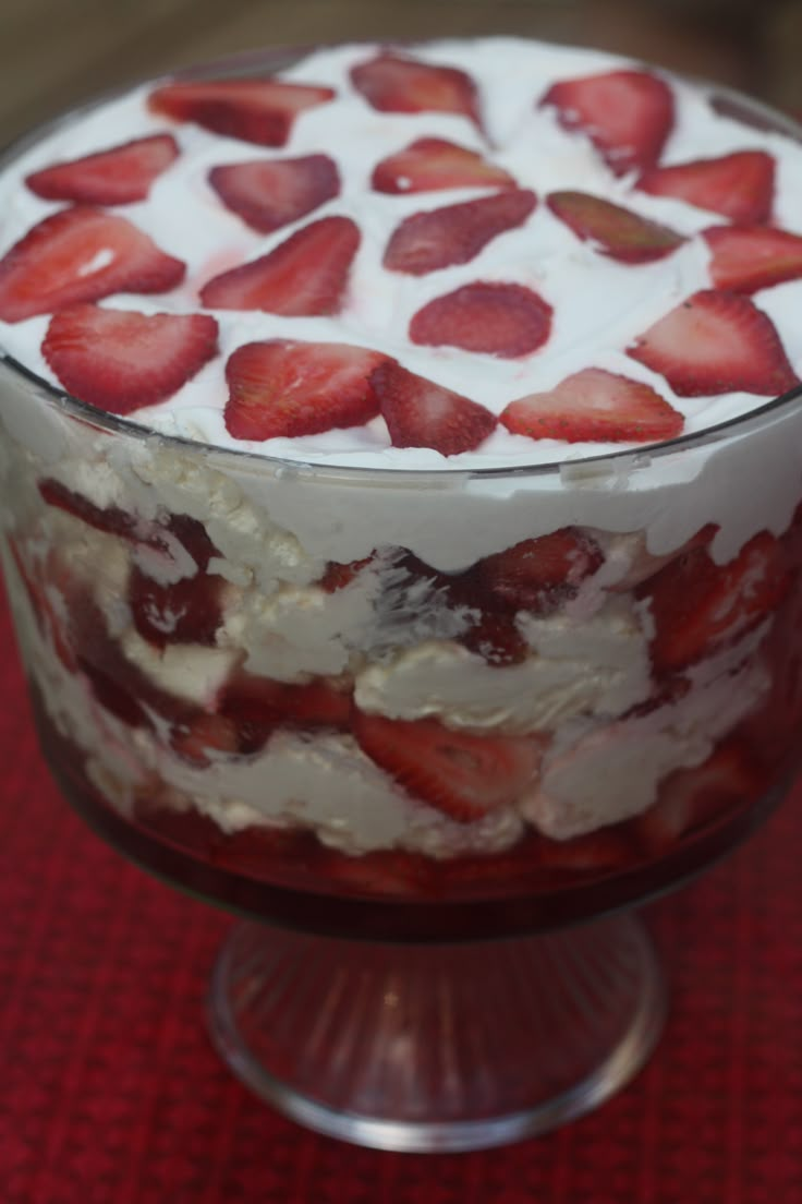 a trifle with strawberries and whipped cream on top