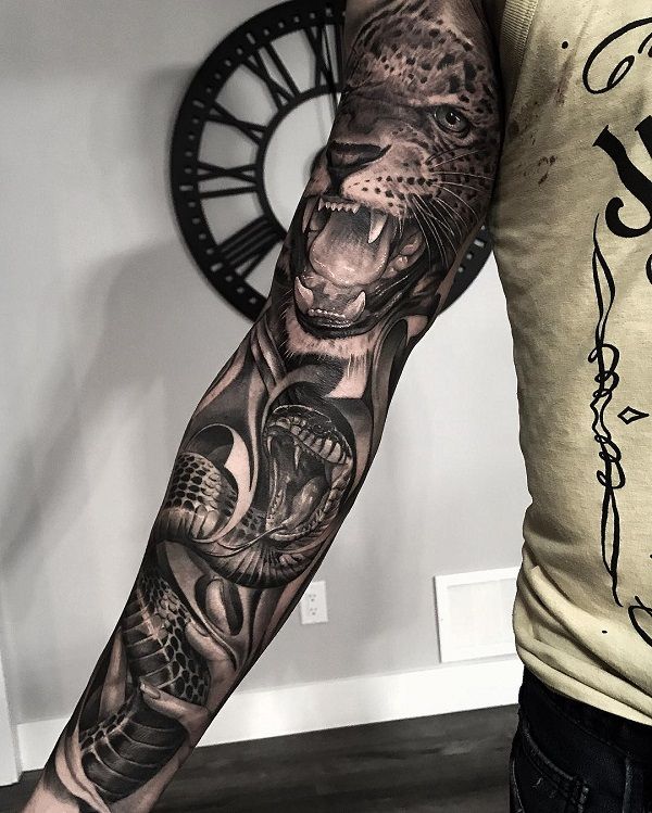 a man with a tiger and snake tattoo on his arm