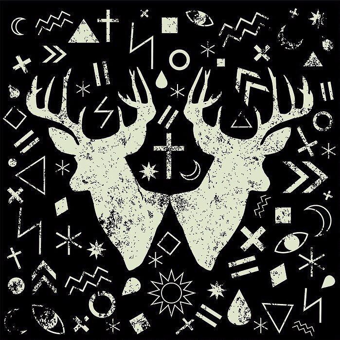 two deers are surrounded by symbols and other things on the black background with white ink