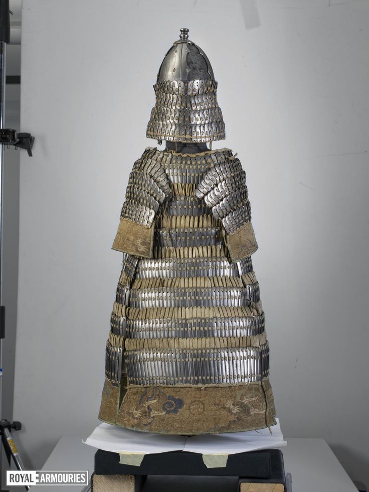 a large metal armor sitting on top of a table