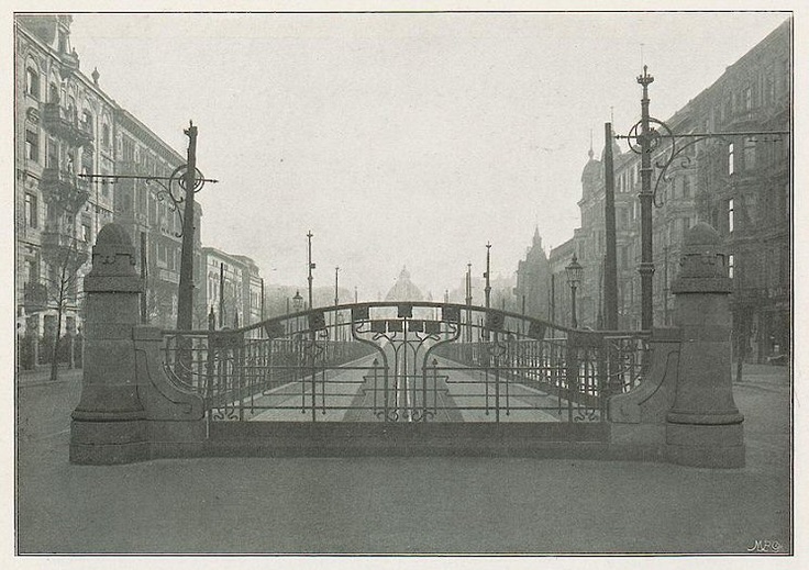 an old black and white photo of a bridge in the middle of a city street