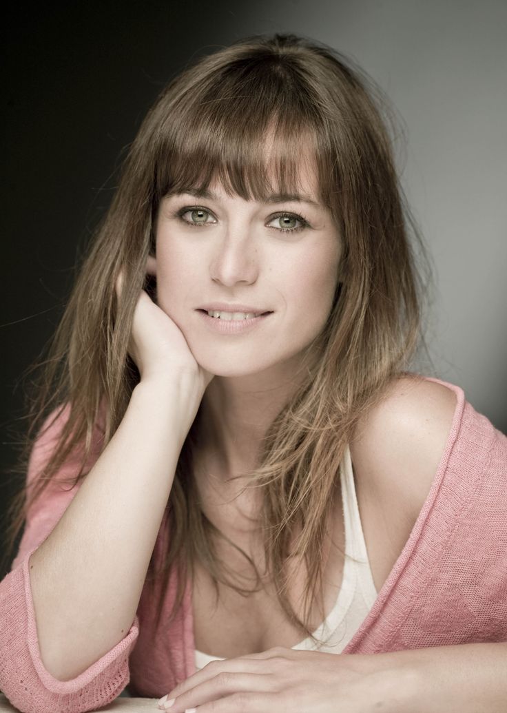 a woman with long hair sitting on a table