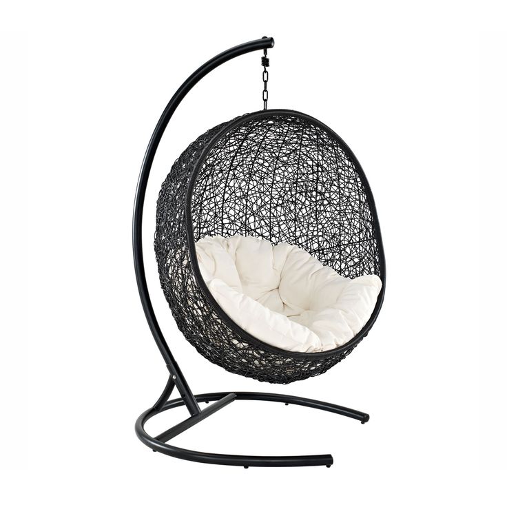 a black hanging chair with white cushions