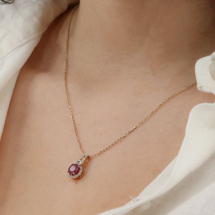 Add a touch of glamour to your neckline with this exquisite Ladies 14k Yellow Gold Fine Chain Ruby and Diamond Necklace. The delicate 21-inch fine chain, with a width of 1.25mm, secures gracefully with a Spring Ring closure. The centerpiece of this necklace is a vibrant round-cut ruby, estimated at 1.1ct, radiating a rich hue. Surrounding the ruby are 37 dazzling round brilliant-cut diamonds, each weighing 0.01ct, with a total carat weight of 0.37ctw. The diamonds exhibit a color range of J-I an Elegant 14k Gold Chain Necklace For Anniversary, Rose Gold Diamond Necklace With Birthstone, Elegant Oval Chain Necklace With Delicate Chain, Elegant Rose Gold Chain Necklace With Round Pendant, Elegant 14k Gold Chain Necklace With Round Pendant, Elegant Teardrop Pendant Birthstone Necklace, Anniversary Delicate Rose Gold Birthstone Necklace, Anniversary Clavicle Chain Necklace With Oval Pendant, Elegant Oval Pendant Birthstone Necklace