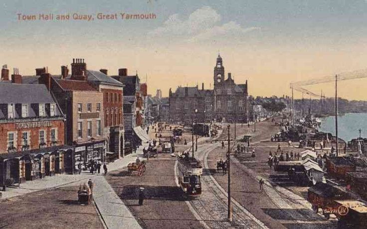 an old photo of a city street with cars parked on the side