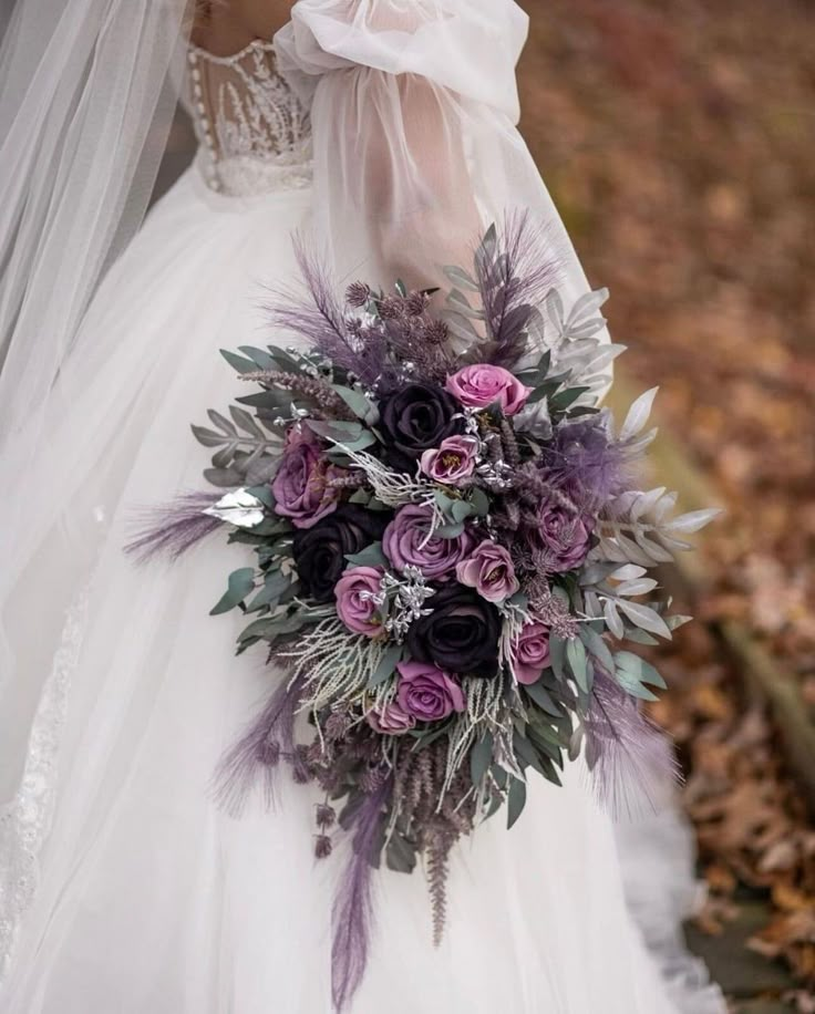 a bridal holding a bouquet of purple flowers