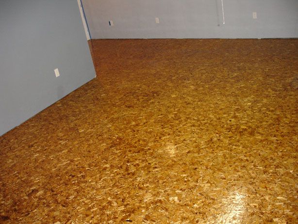 an empty room with wood flooring and white walls