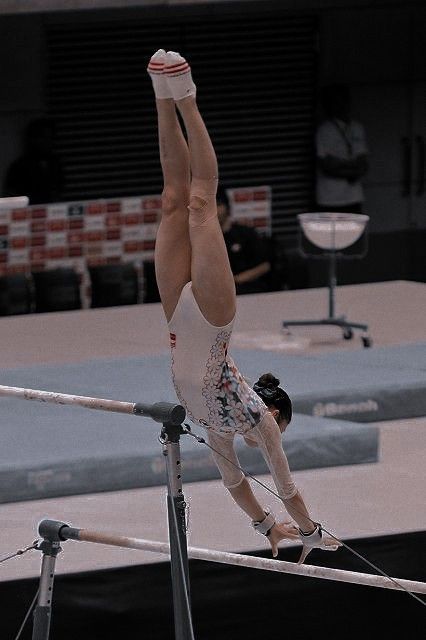 a person on a balance beam doing a handstand