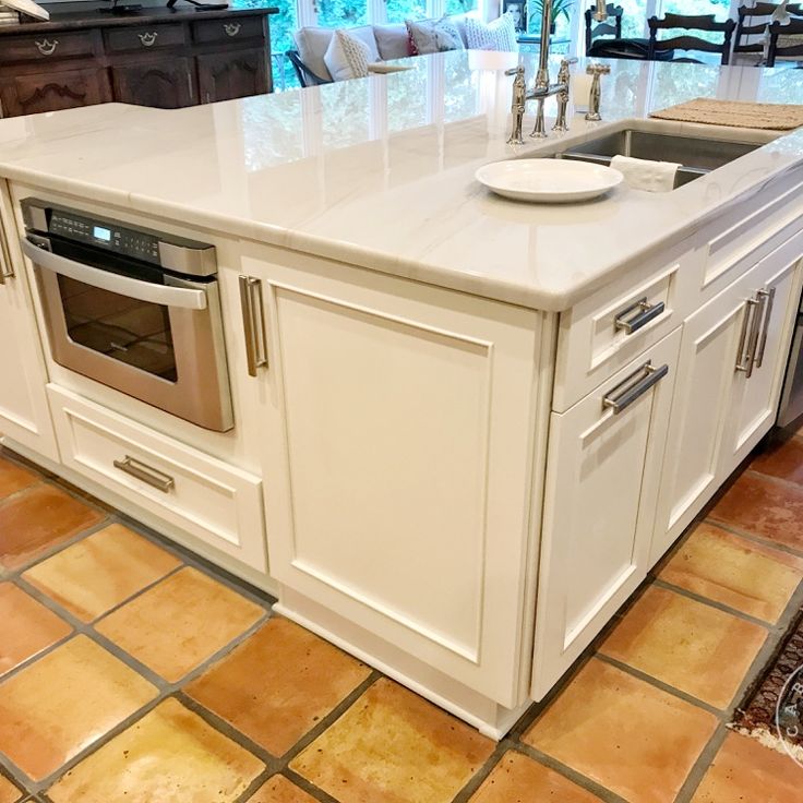 Large white island with microwave drawer. Kitchen island