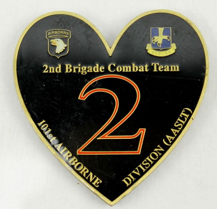 a black and gold heart shaped badge with the number two on it's side