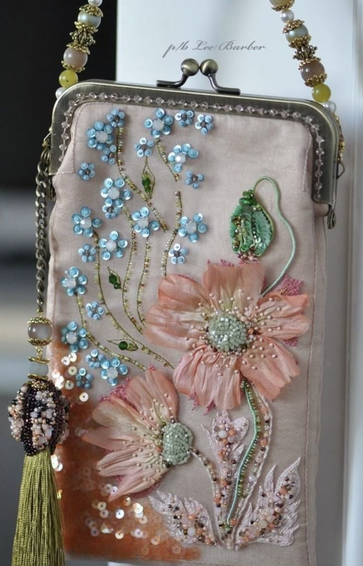 a purse with flowers and beads hanging from it