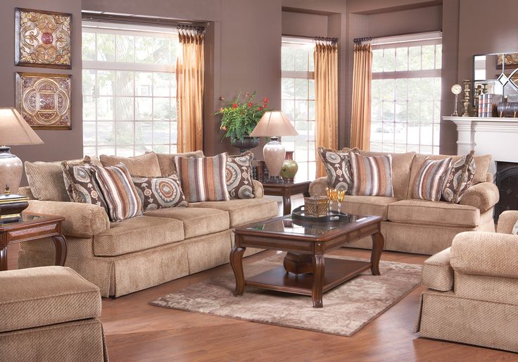 a living room filled with furniture and a fire place in the middle of a room