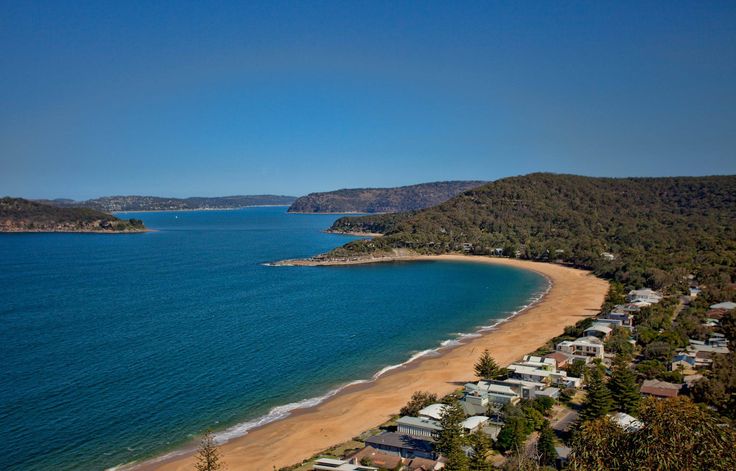 an aerial view of a beach with houses on it and the ocean in the background