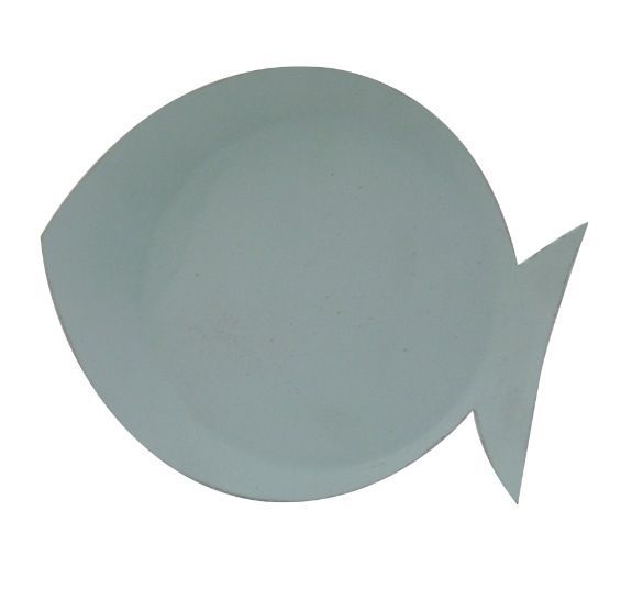 a white fish shaped plate sitting on top of a table