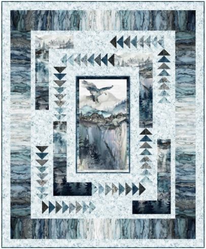 a quilted wall hanging with an image of a bird flying over the water and mountains