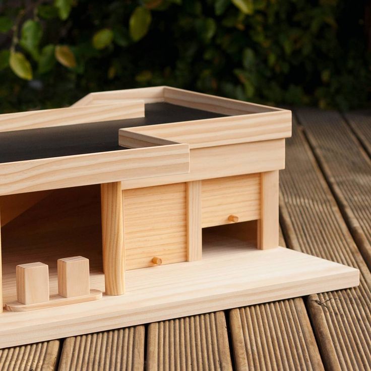 a wooden model of a house on a table