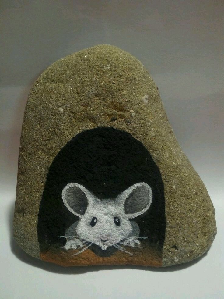 a rock with a painting of a mouse on it