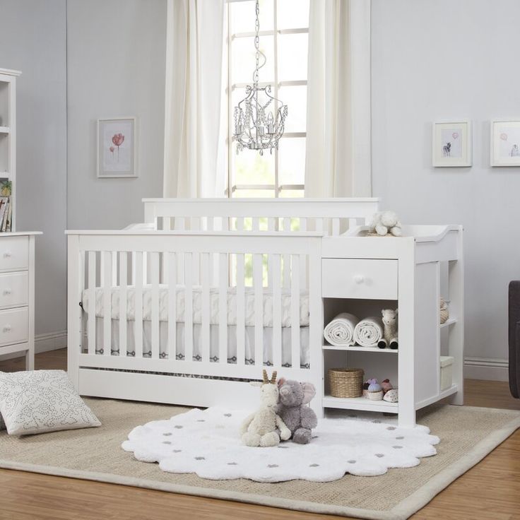 a white baby crib in a nursery room