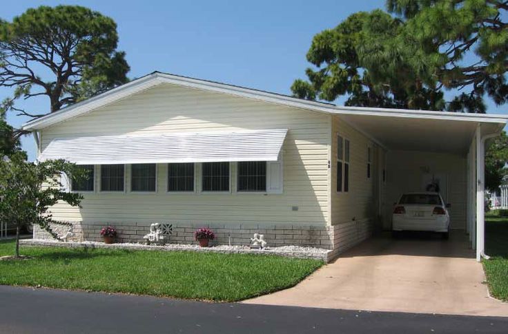 a white house with a car parked in the driveway